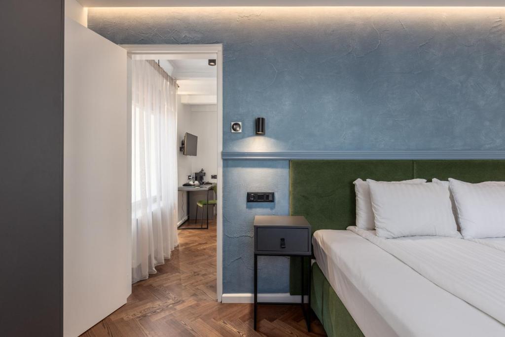 Postel nebo postele na pokoji v ubytování Konventa Sēta Hotel Keystone Collection