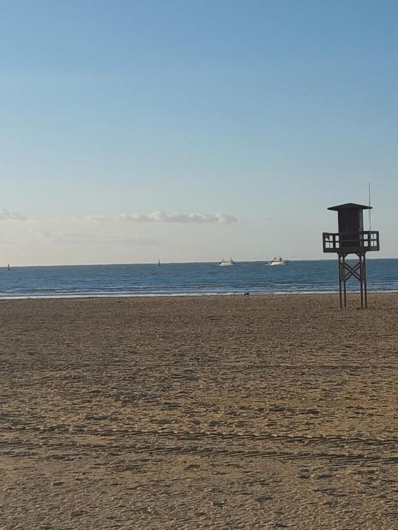 a life guard stand on a beach with the ocean at PLAYA LAS PILETAS-CALZADA in Sanlúcar de Barrameda