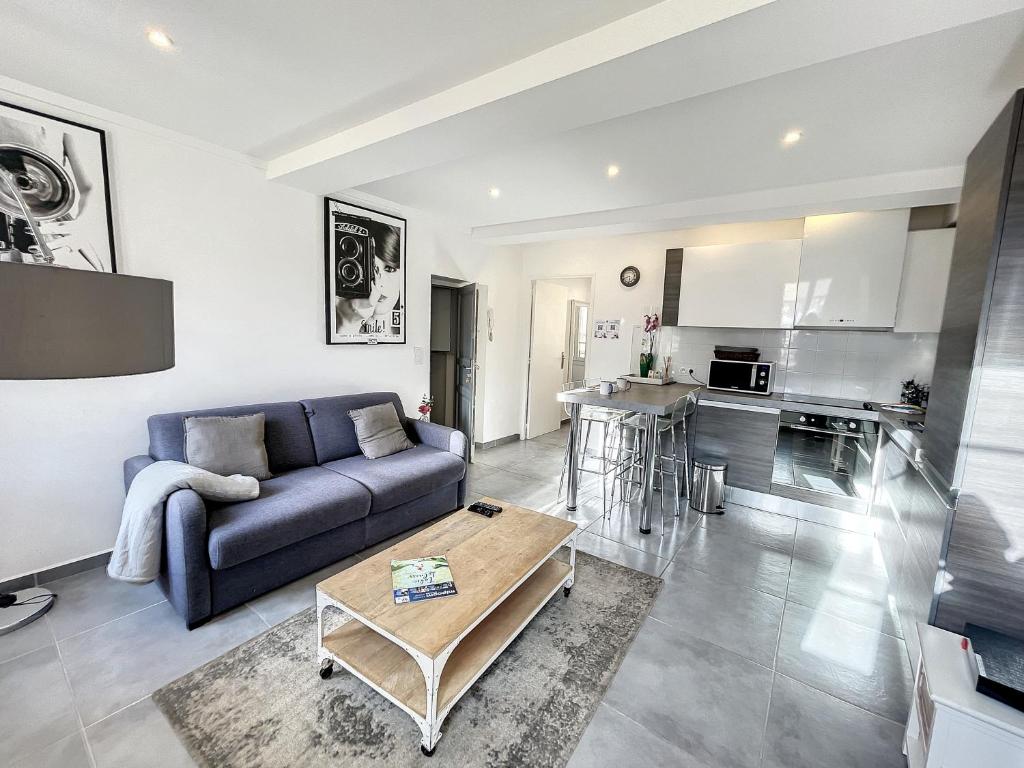 un salon avec un canapé et une table dans l'établissement Cannes Croisette Rue Meynadier Palais 1 mn Modern 1 BR by Olam Properties, à Cannes