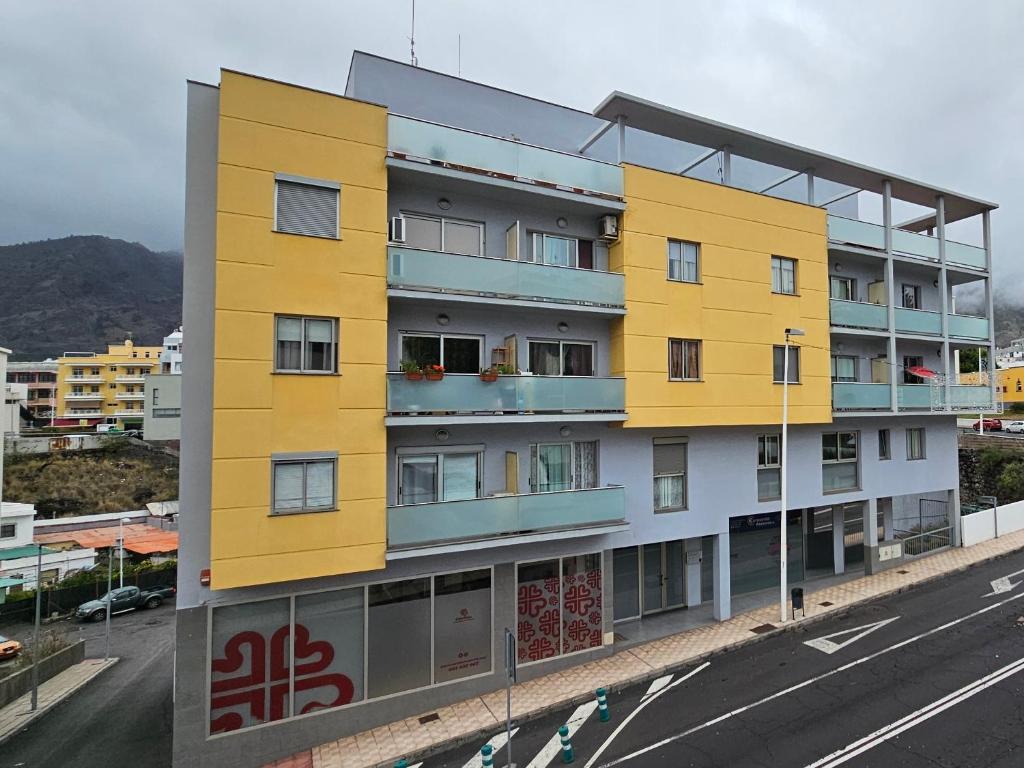 um edifício amarelo no lado de uma rua em Vivienda vacacional Rous em Los Llanos de Aridane