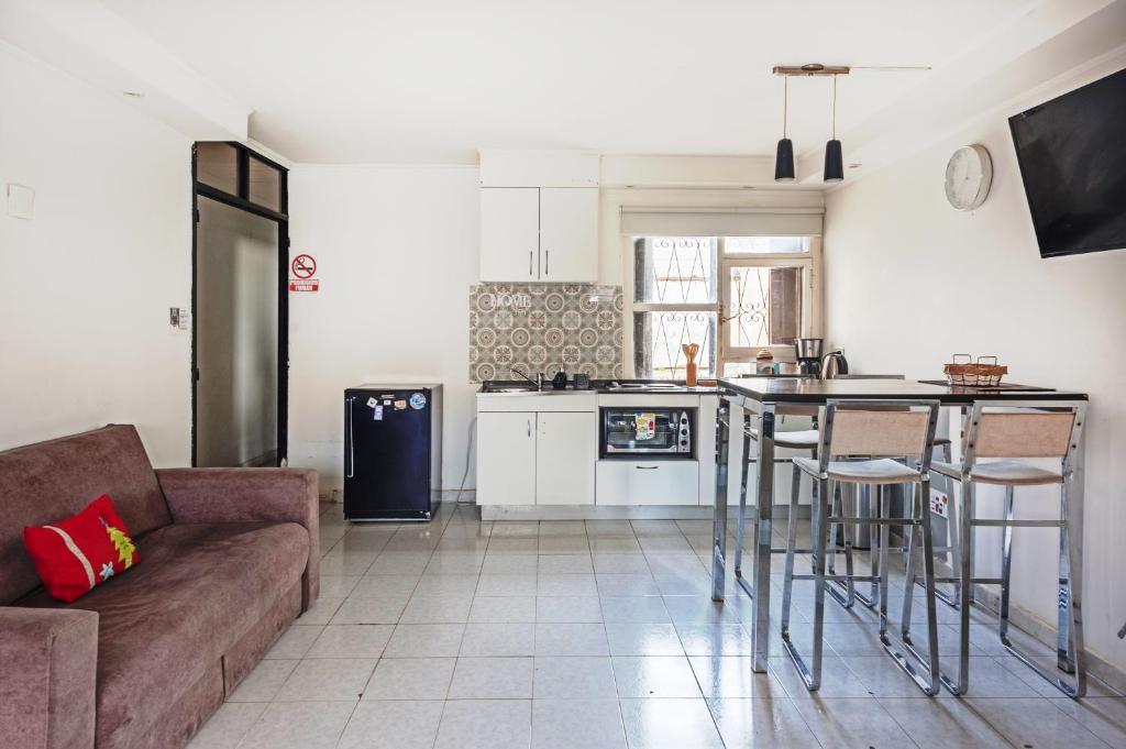 a kitchen and living room with a couch and a table at Carabelli Propiedades II in Río Grande