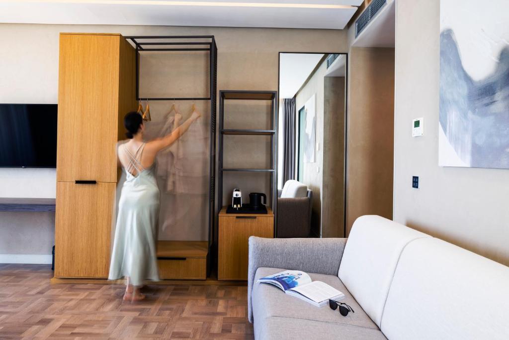 a woman is standing in front of a door at La Brisa Boutique Hotel in Dhërmi