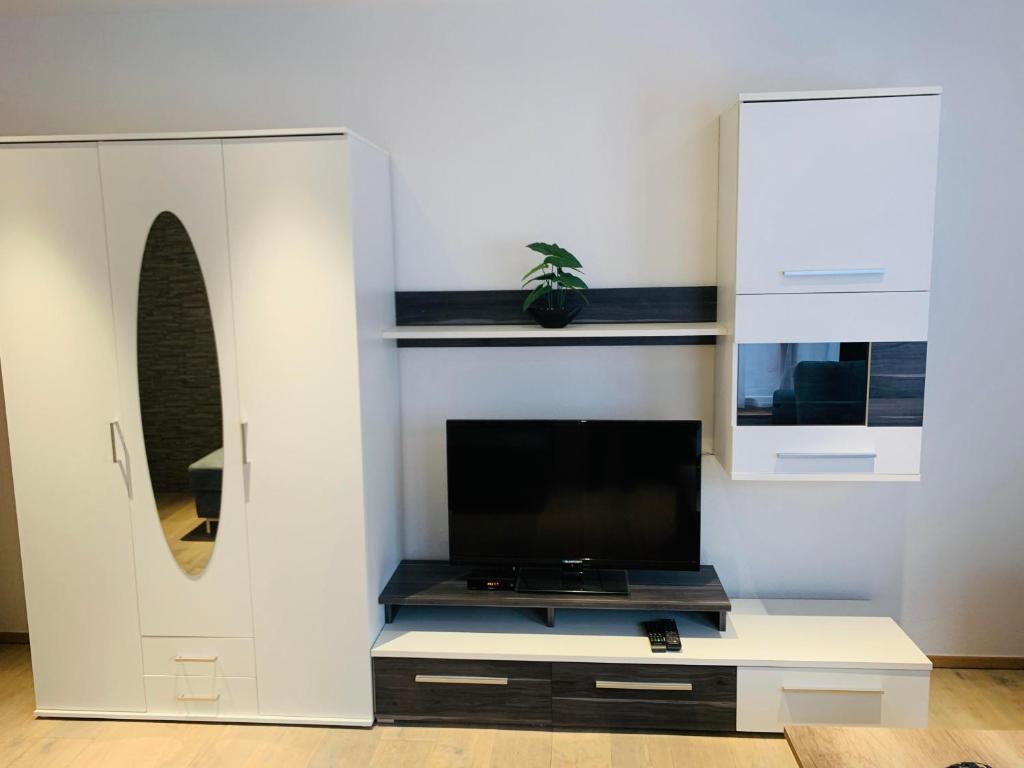 a living room with a tv and a white cabinet at Ferienhaus Julia in Oetz