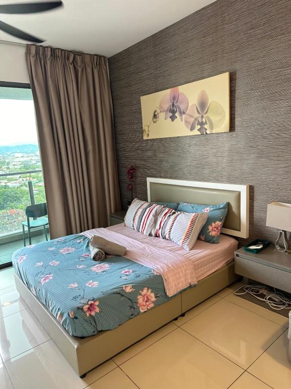 a bedroom with a bed with a blue comforter at Evo Soho in Bandar Baru Bangi