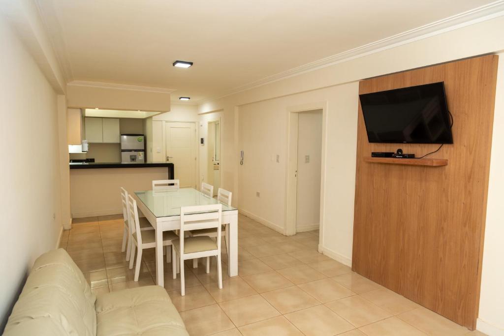 a living room with a table and a couch and a television at Departamentos T&M in Santiago del Estero