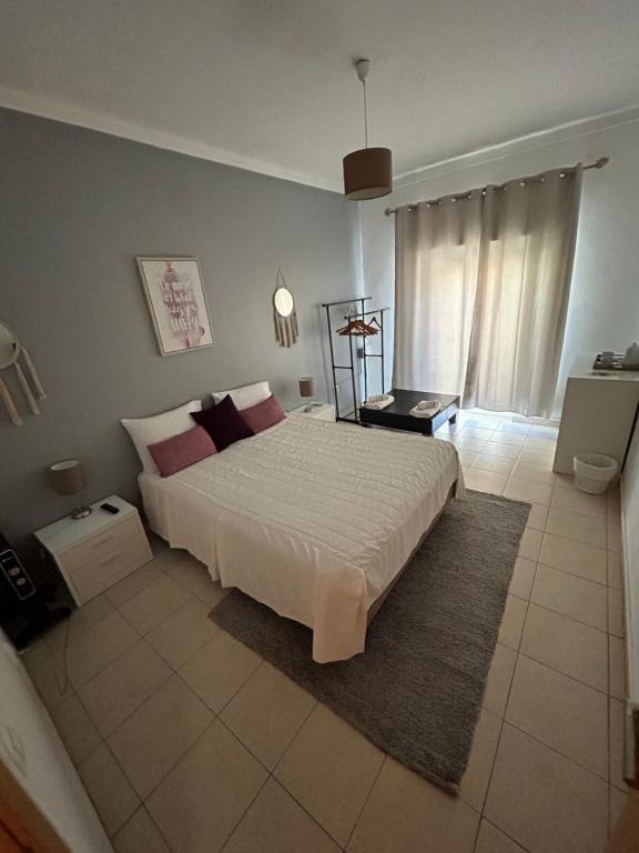 a bedroom with a large white bed in a room at Sun Place Guest House in Lagos