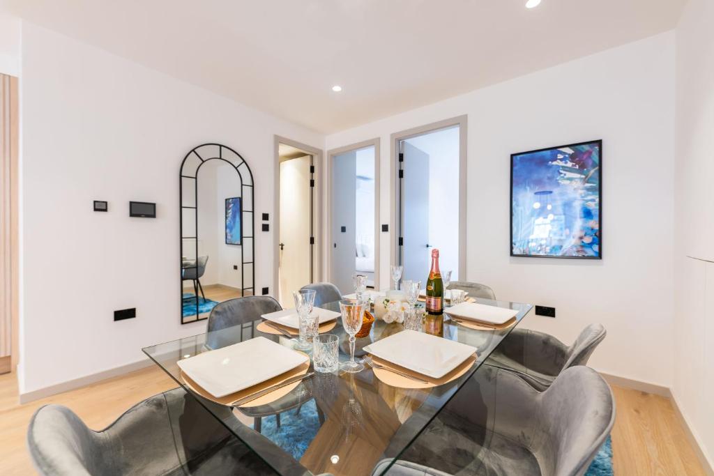 a dining room with a glass table and chairs at The Maida Vale in London