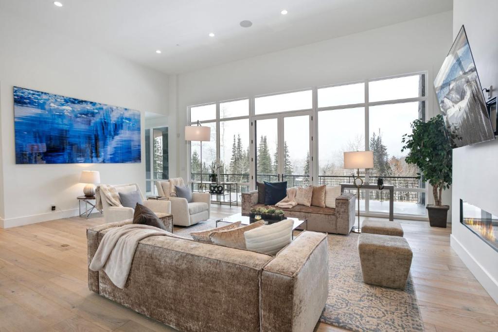 a living room with couches and a large window at Quicksilver Haus in Park City