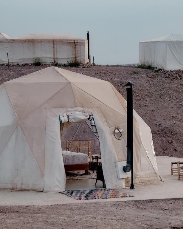 a tent in the middle of a field at Emeraude Camp Agafay in El Karia