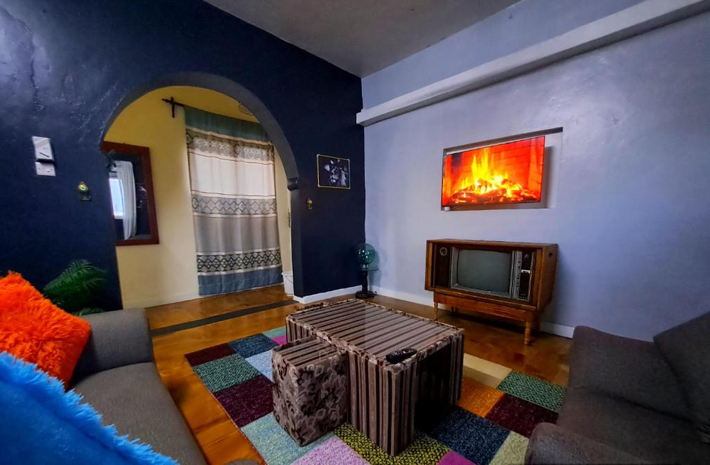 a living room with a couch and a tv at Zahra Homes in Mombasa