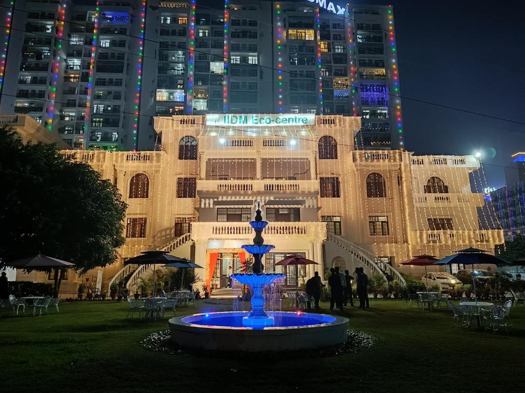 a fountain in front of a building at night at IIDM Eco Centre in Lucknow