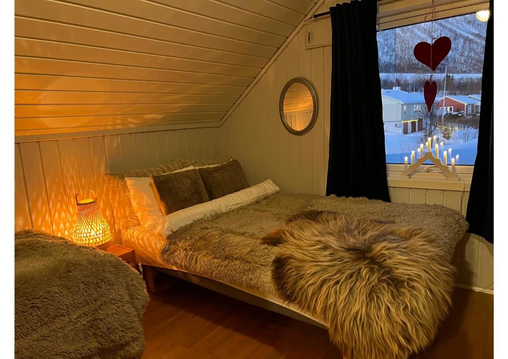 a bedroom with a bed with a furry blanket at Rigmorhuset in Fjordgård