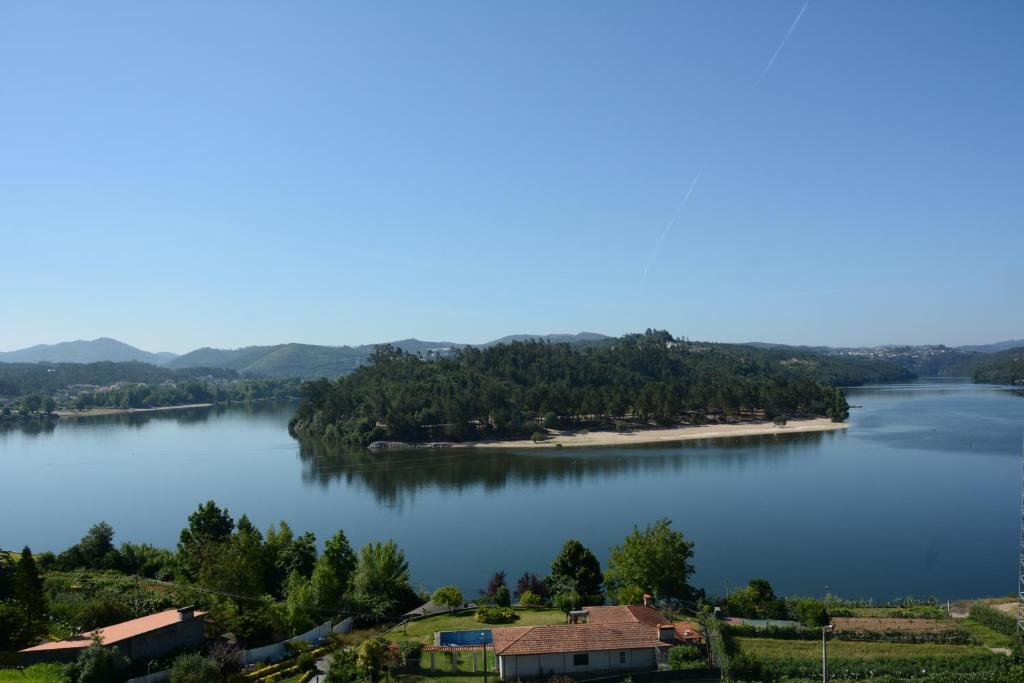an island in the middle of a large lake at Figurino do Douro in Melres