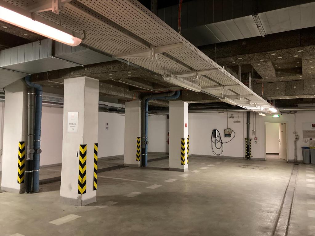 an empty parking garage with columns and pipes in it at Clarion Congress Hotel Bratislava in Bratislava