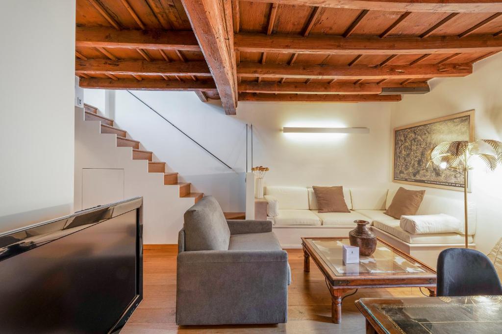 a living room with a couch and a tv at Milan Royal Suites - Castello in Milan