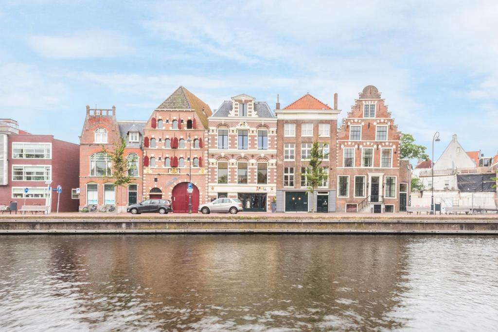 
a row of buildings on the side of a river at Spaarne Apartment in Haarlem
