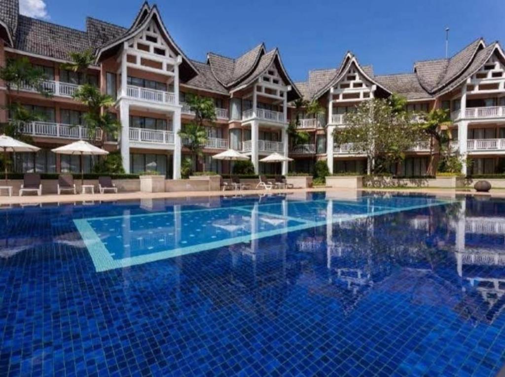 a swimming pool in front of a hotel at Allamanda 3 Laguna in Bang Tao Beach