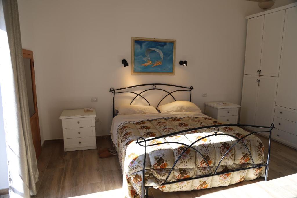 - une chambre avec un lit et une peinture murale dans l'établissement Salento casevacanza Maria, à Galatina