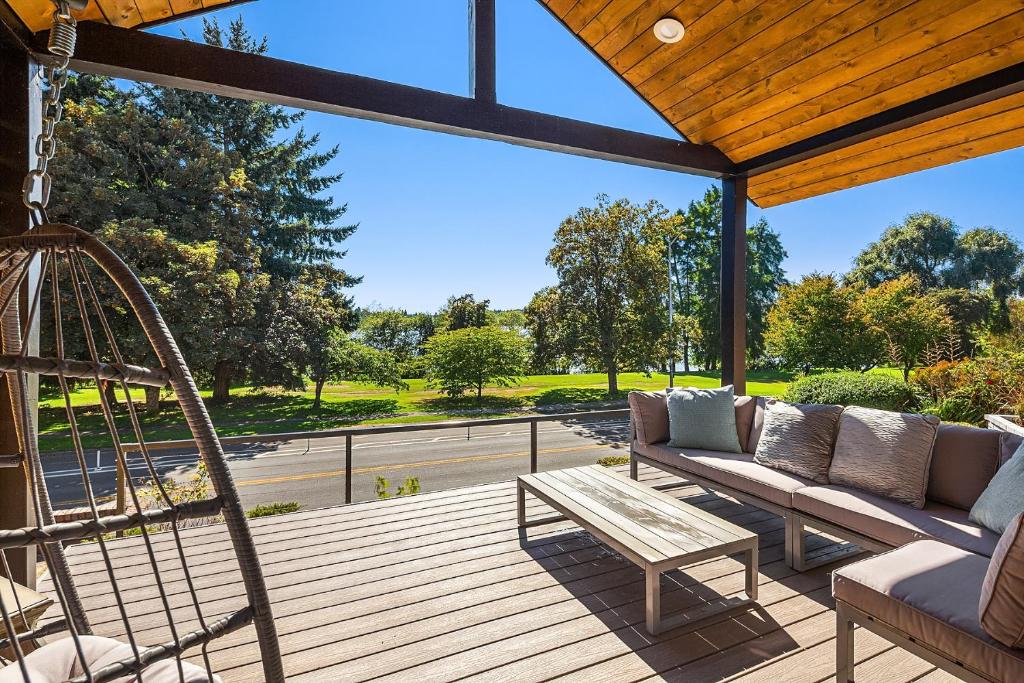 a porch with a couch and a swing at Green Lakefront Villa in Seattle