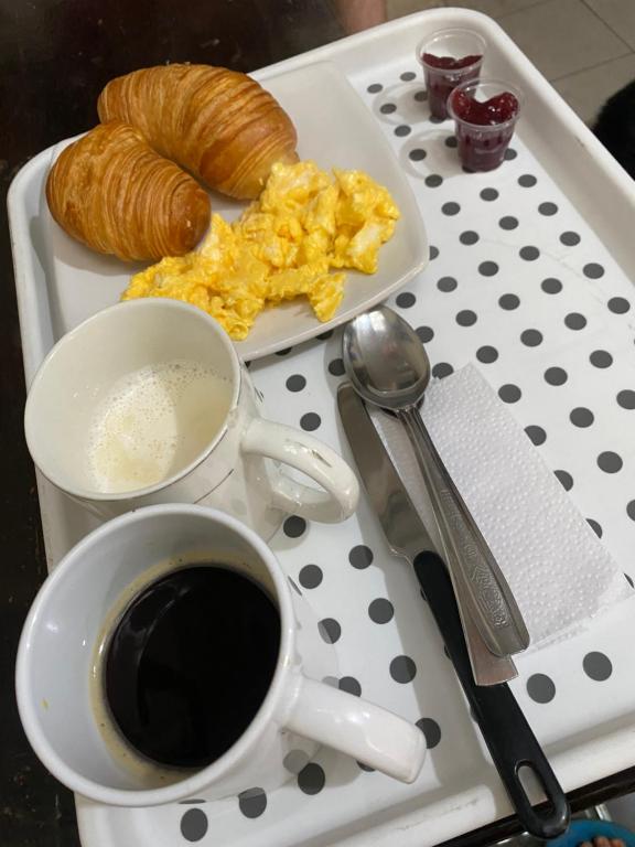 a tray with a cup of coffee and a plate of breakfast food at Bogotá Kings 101 in Bogotá