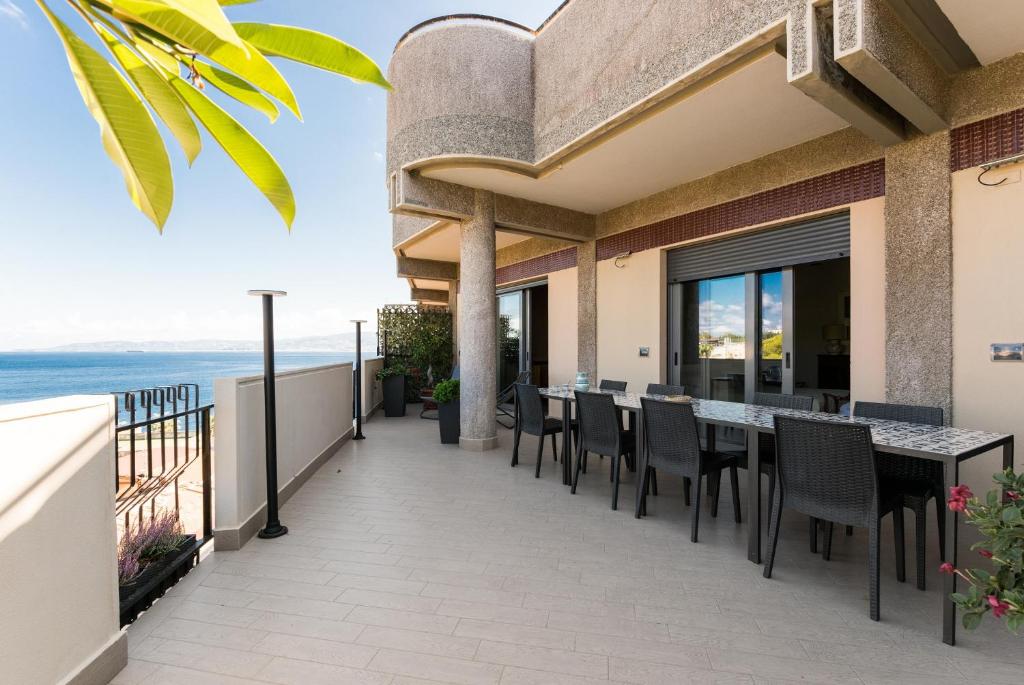a patio with a table and chairs on a balcony at Attico Panoramico - Milazzo Centro Storico - 200 mq in Milazzo