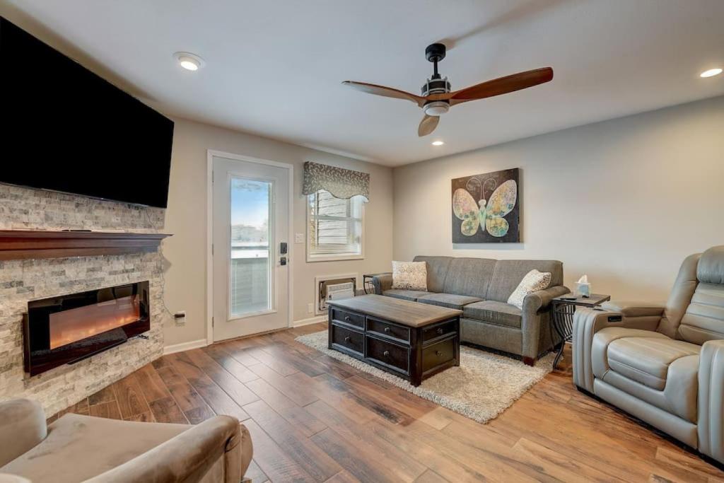 a living room with a couch and a fireplace at Dells Lakefront Escape - Couples or Families in Wisconsin Dells