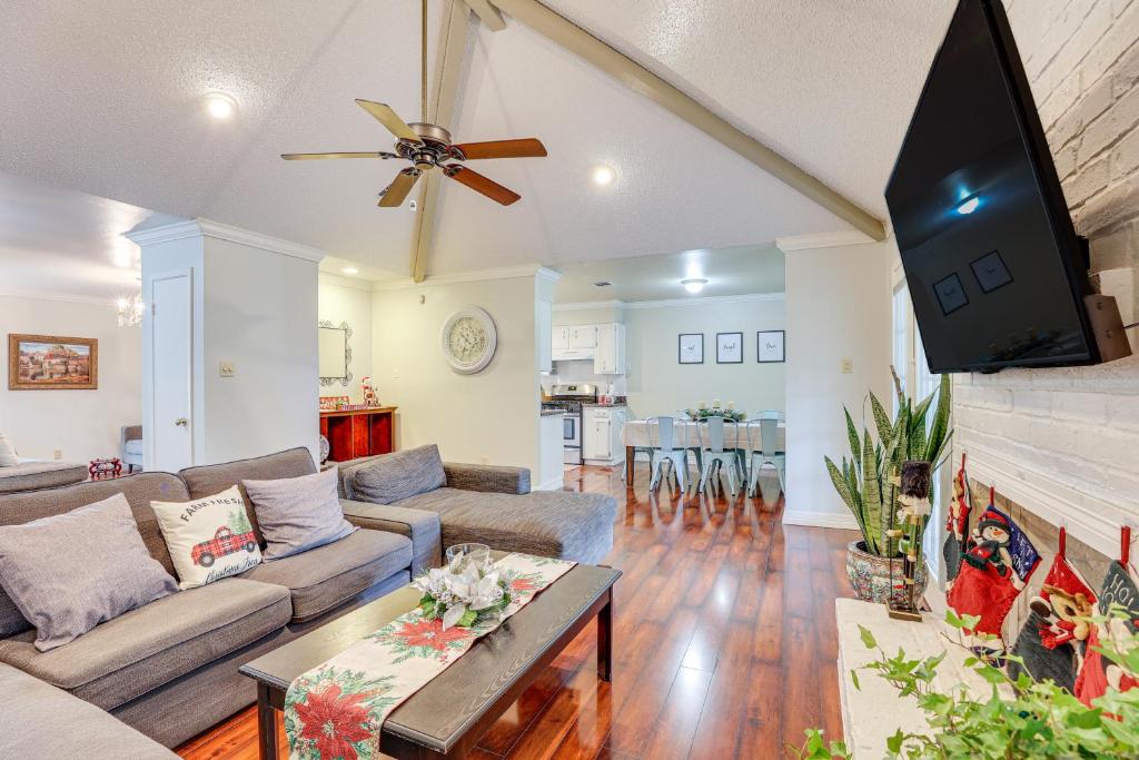 a living room with a couch and a flat screen tv at Houston Home with Screened Porch, Near Sugar Land! in Houston