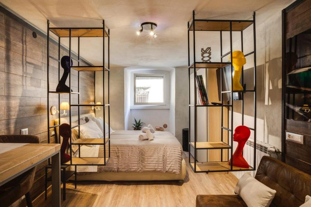 Un dormitorio con una cama y estanterías. en La Casa dello Stilista en Brescia