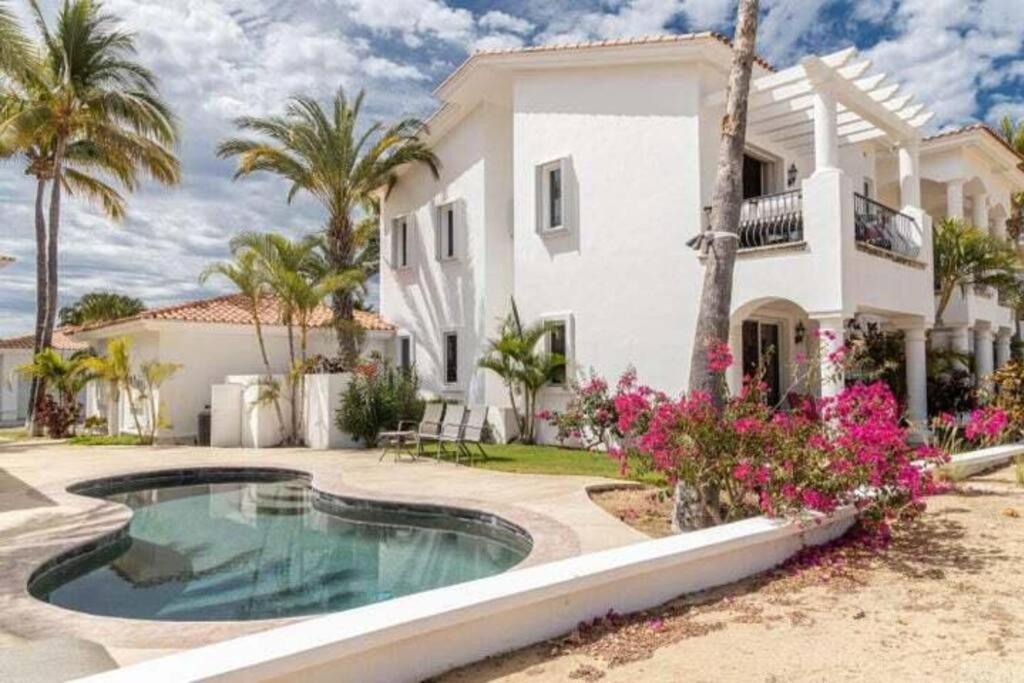 a house with a swimming pool in front of it at Beautiful 2 Bedroom Condo in Palmilla in San José del Cabo