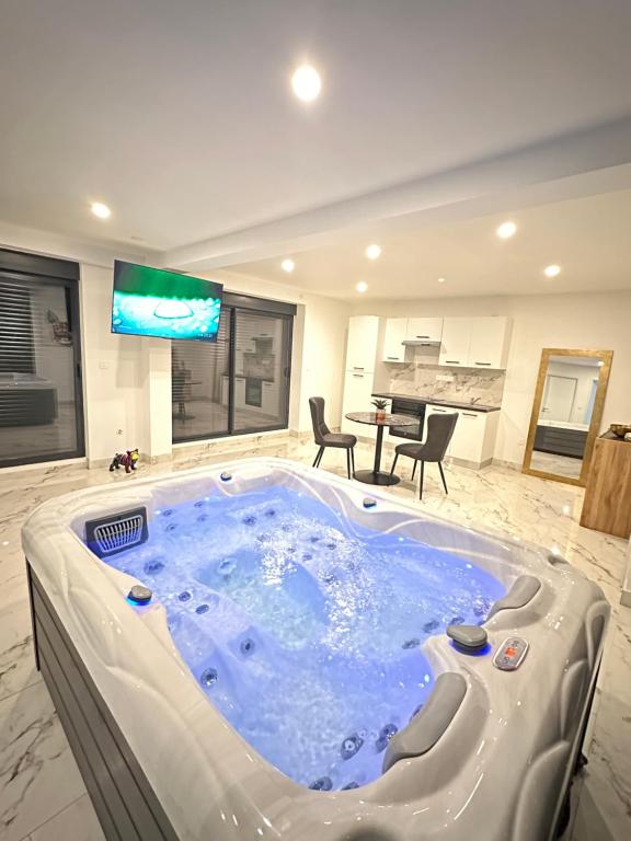 a large jacuzzi tub in a living room at Appartement cosy jacuzzi spa 70M2 in Châtenois