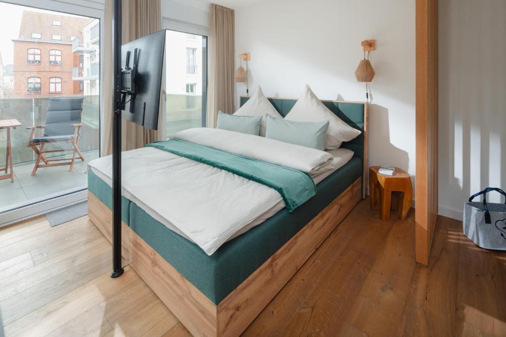 Rúm í herbergi á Haus Noena - Wohnung 7 Inselschatz