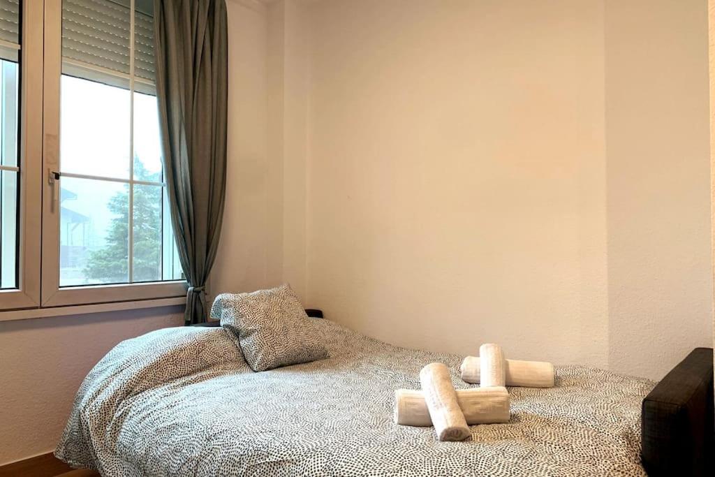 a bedroom with a bed with two stuffed animals on it at Estudio Plaza Maribel con parking incluido in Sierra Nevada
