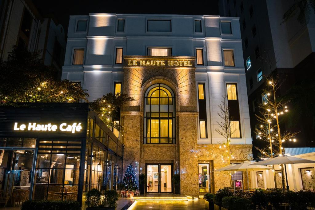 a building with a sign on it at night at Le Haute Hotel Hai Phong in Hai Phong