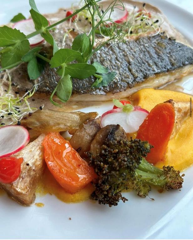a plate of food with fish and vegetables on it at Hôtel du Musée in Granville