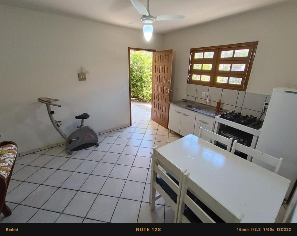 a kitchen with a table and a treadmill in it at Casa PRAIA DOS INGLESES in Florianópolis