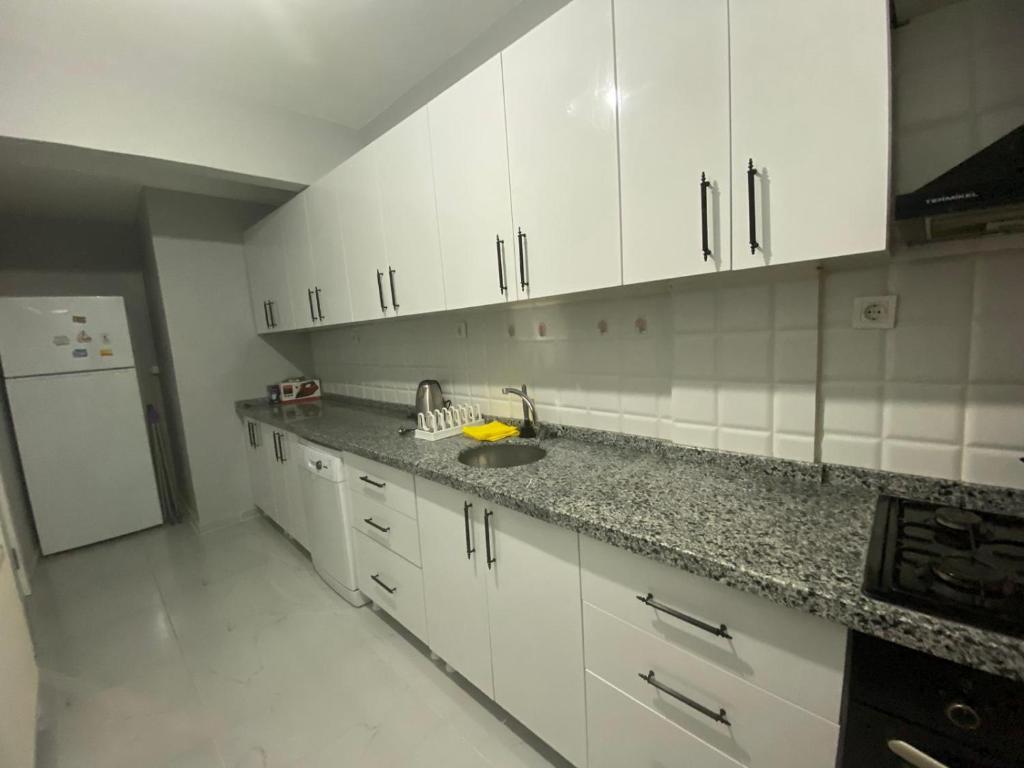a kitchen with white cabinets and a sink at 12345 in Istanbul
