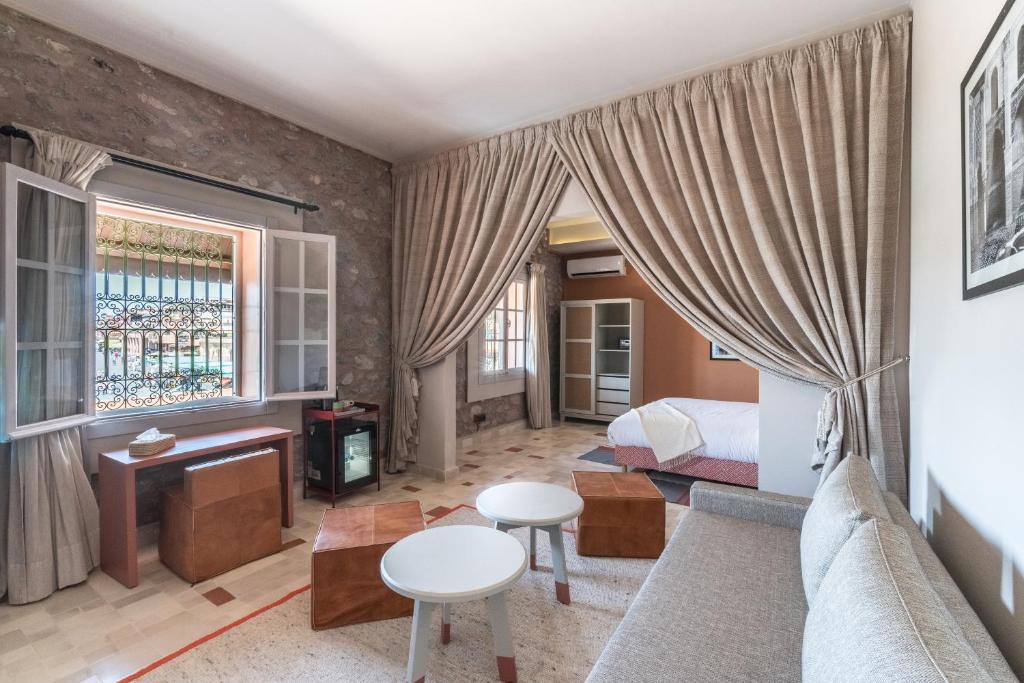 a living room with a couch and a bed and a table at JEMAA EL FNA Suites & Spa in Marrakech