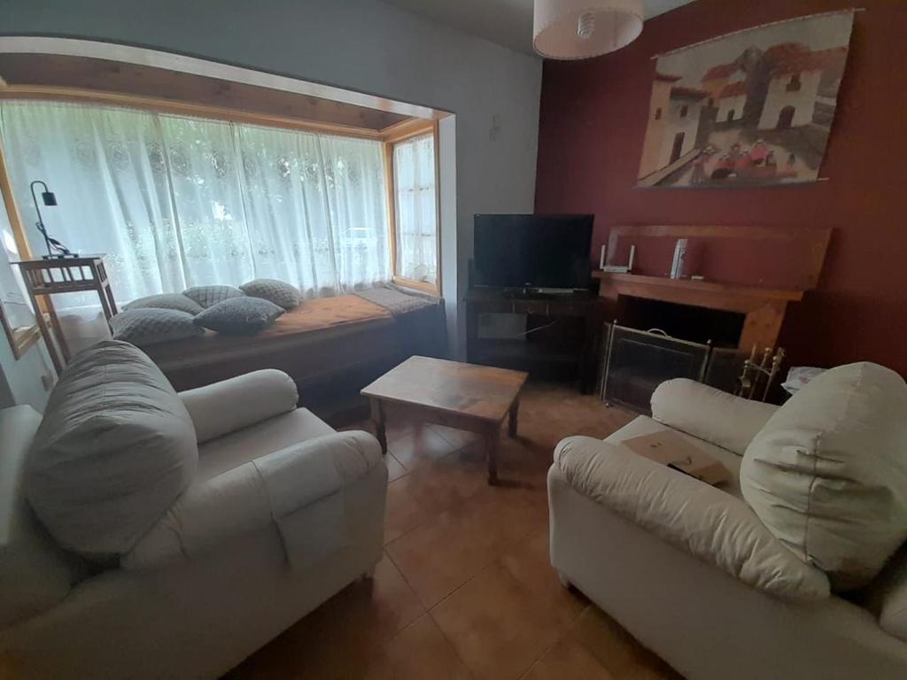 a living room with two couches and a tv at La Casa de la Isla in San Martín de los Andes