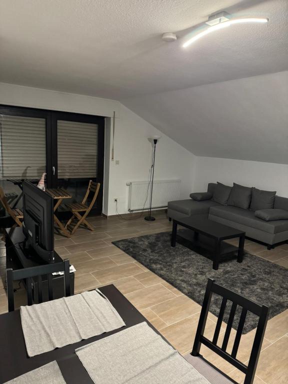 a living room with a couch and a table at Wohnung mit Küche, Fernseher, WLAN und Parkplatz - Brian in Werne an der Lippe