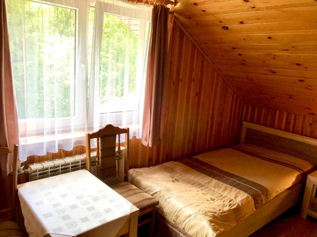 um quarto com 2 camas individuais e uma janela em Zakątek em Wysowa-Zdrój