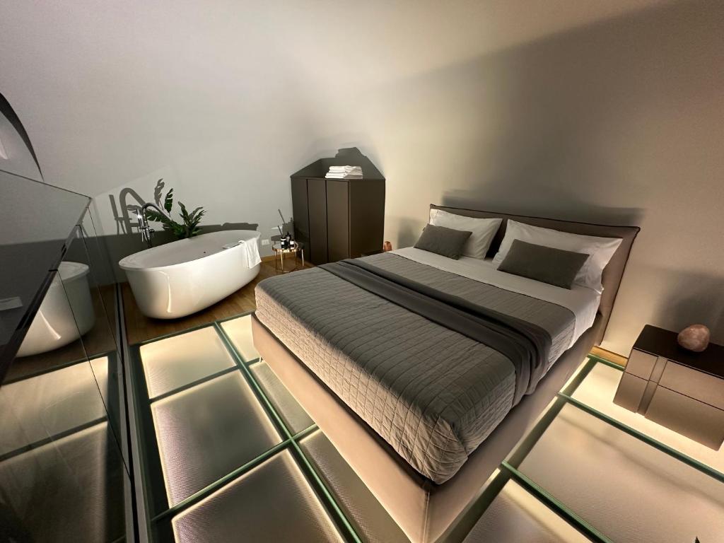 - une chambre avec un lit, une baignoire et un lavabo dans l'établissement Jacuzzi Luxury Apartment in the Town Centre, à Turin