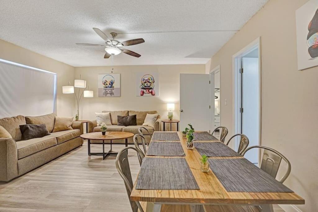 a living room with two tables and a couch at The Oceans Cozy 2BR Apartment in Victoria Park in Fort Lauderdale