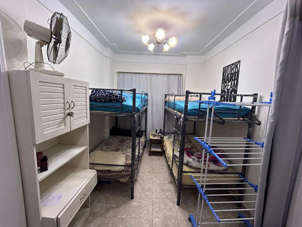 a room with three bunk beds and a ceiling at Victoria Hostel in Alexandria