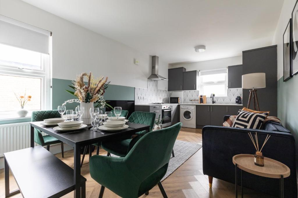 a kitchen and dining room with a table and chairs at Beautiful 3BR Flat with Desks and Fast Wi-Fi in London