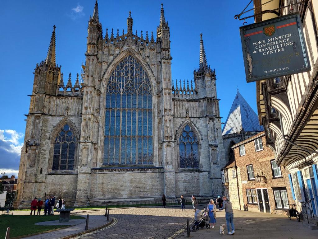 a large cathedral with people standing in front of it at York Minster View in York