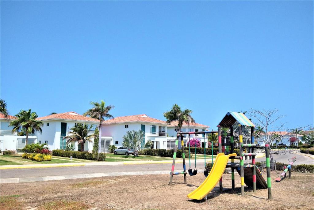 a playground in front of a house with a slide at Villla en la playa Cartagena 5 in Cartagena de Indias