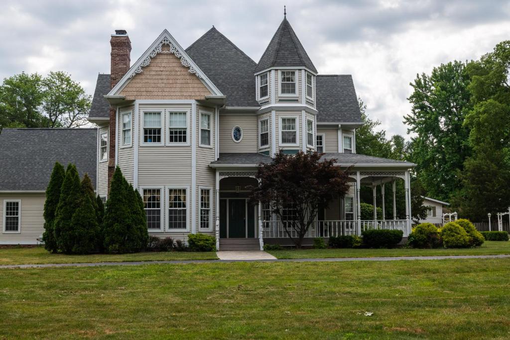 a large white house with a turret at Exquisite Victorian in Springfield