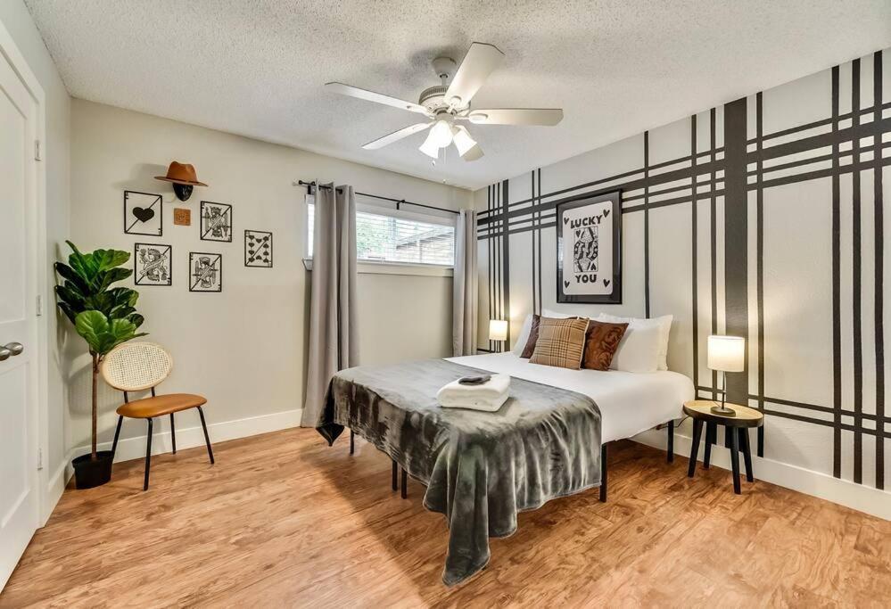 a bedroom with a bed and a ceiling fan at Near Downtown Dallas - The Dapper Charm in Dallas