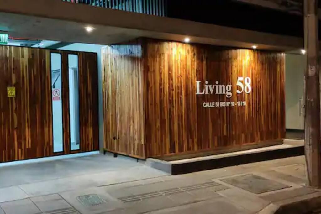 a lobby of a building with a wooden wall at AC - Living 58 - Chapinero - Apartasuites in Bogotá