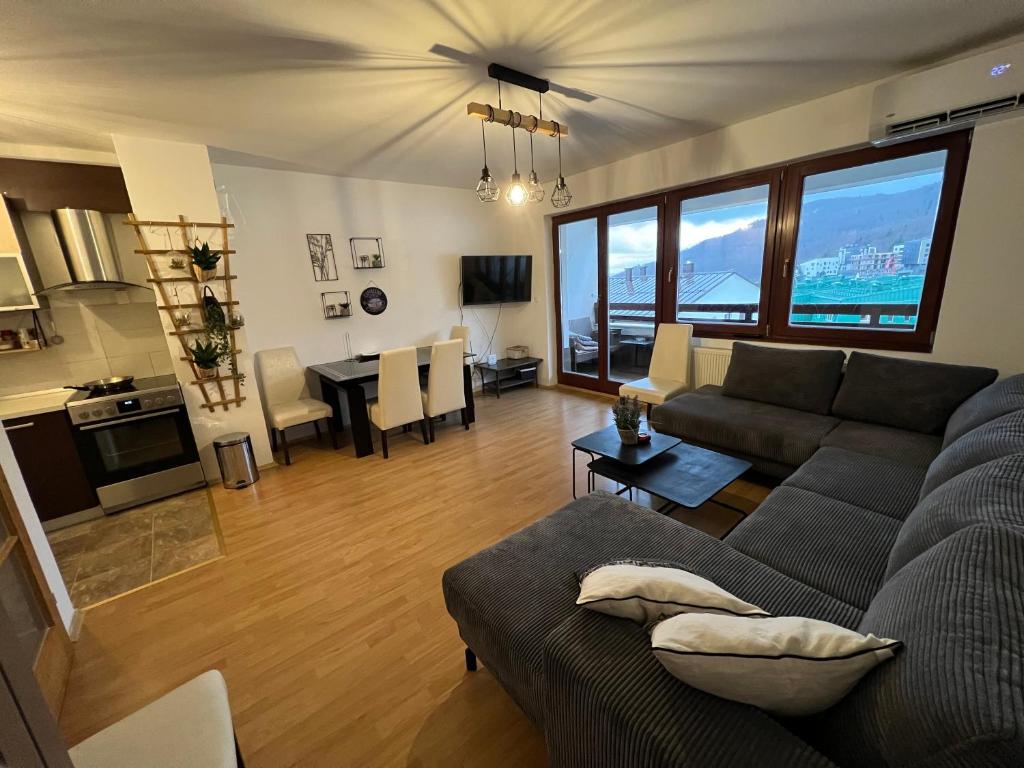 a living room with a couch and a table at Apartman Nai in Bjelašnica